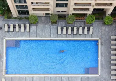 a large swimming pool in front of a building at Burj Khalifa View Downtown Gem, 8 Minutes Walk to Dubai Mall in Dubai