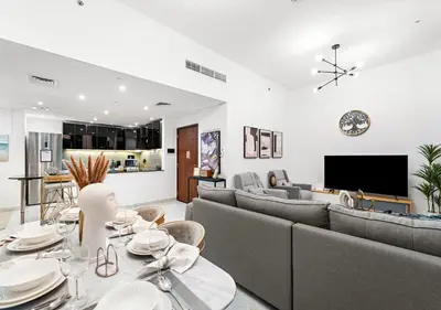 a living room with a couch and a dining room at Burj Khalifa View Downtown Gem, 8 Minutes Walk to Dubai Mall in Dubai