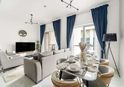 a living room with a couch and a table at Burj Khalifa View Downtown Gem, 8 Minutes Walk to Dubai Mall in Dubai