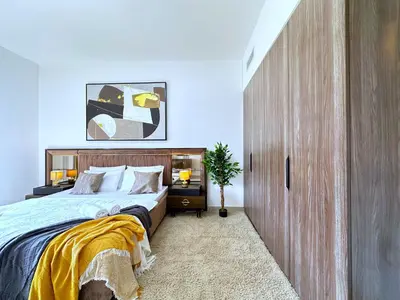 a bedroom with a large bed with a wooden headboard at MegaLuxury Flat Resort, Amazing Pool, Burj direct View in Dubai