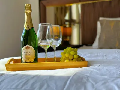 a tray with a bottle of wine and two glasses at MegaLuxury Flat Resort, Amazing Pool, Burj direct View in Dubai