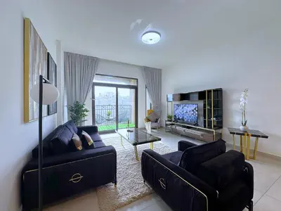 a living room with two couches and a television at MegaLuxury Flat Resort, Amazing Pool, Burj direct View in Dubai