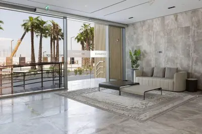 a living room with a couch and a table at Sukoon's Elegant Suite in Dubai