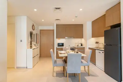 a kitchen and dining room with a table and chairs at Dubai Creek in Dubai