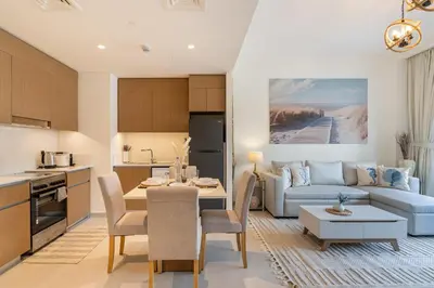 a kitchen and living room with a couch and a table at Dubai Creek in Dubai