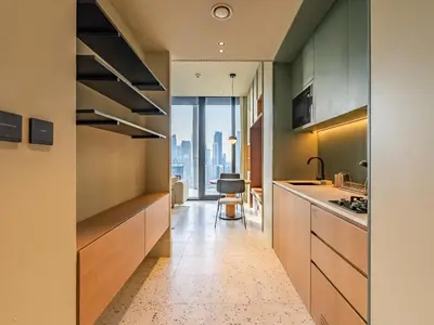 a kitchen with wood cabinets and a view of the city at Modern Studio at Upside Living, Business Bay with Burj Khalifa View in Dubai