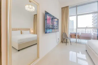 a bedroom with a mirror and a bed and a window at Modern 2BR I Partial Burj Khalifa & Boulevard View in Dubai