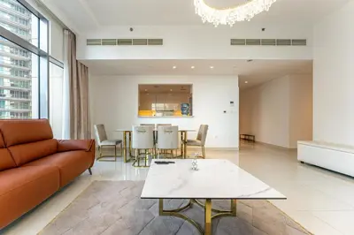 a living room with a couch and a table at Modern 2BR I Partial Burj Khalifa & Boulevard View in Dubai
