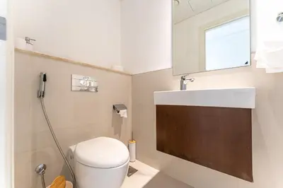 a bathroom with a toilet and a sink at Modern 2BR I Partial Burj Khalifa & Boulevard View in Dubai