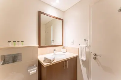a bathroom with a sink and a mirror at Modern 2BR I Partial Burj Khalifa & Boulevard View in Dubai