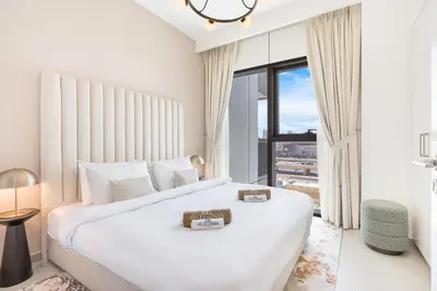 a white bedroom with a large bed and a large window at Premium Downtown Home with Burj Khalifa View in Dubai