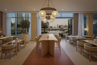 a restaurant with tables and chairs and windows at Vida Dubai Mall in Dubai