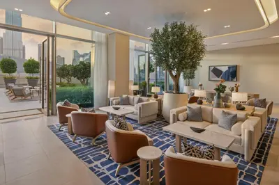 a lobby with couches and tables and windows at Vida Dubai Mall in Dubai