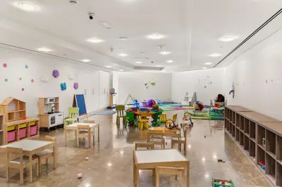 a classroom with tables and chairs and a play area at DIFC Downtown Dubai - Exclusive 1 BR in Dubai