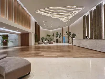 a lobby with a large lobby with a large ceiling at DIFC Downtown Dubai - Exclusive 1 BR in Dubai