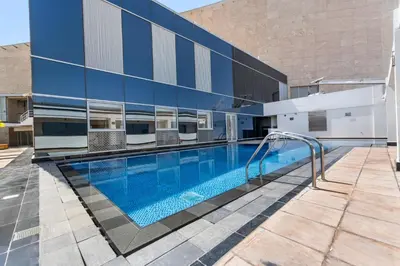 a swimming pool in front of a building at DIFC Downtown Dubai - Exclusive 1 BR in Dubai