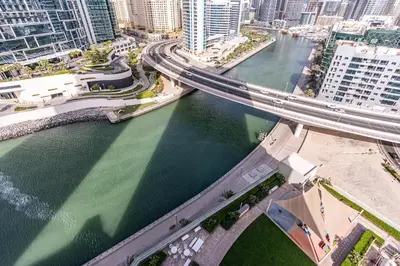 an aerial view of a bridge over a river at Luxurious 2BR Home with Stunning Marina Skyline View in Dubai