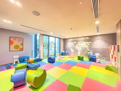 a room with a brightly colored room with chairs and tables at Luxurious 2BR Home with Stunning Marina Skyline View in Dubai