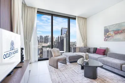 a living room with a couch and a tv at Luxurious 2BR Home with Stunning Marina Skyline View in Dubai
