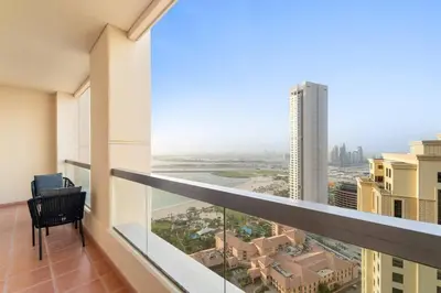 a balcony with a view of a city at Stunning Sea & Palm View 2BR, Steps from JBR Beach & Waterfront in Dubai