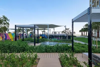 a playground in a park with a canopy at Special Offer Refined Studio with City Views by Deluxe Holiday Homes in Dubai