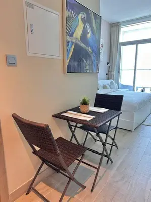 a room with a table and chairs and a bed at Lujo Dubai Marina in Dubai