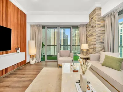 a living room with a couch and a tv at Elegant Two Bedroom Apartment with Large Balcony and Panoramic Downtown Skyline & Boulevard Views by Luxury Space in Dubai