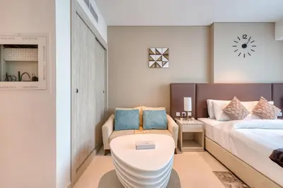 a bedroom with a bed and a toilet at Beachfront Studio Right by Nakheel Mall in Dubai