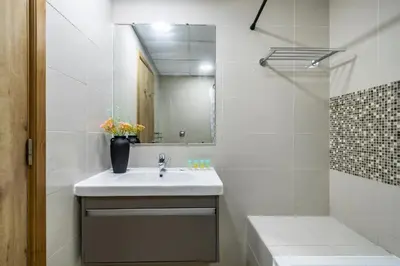 a white bathroom with a sink and a mirror at ShoresInn - Marvelous Marina View In Dubai in Dubai