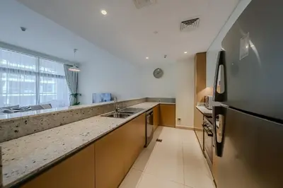 a kitchen with a sink and a refrigerator at Modern 2BDR Apartment I Dubai Hills I City View I Mulberry at Park Heights in Dubai