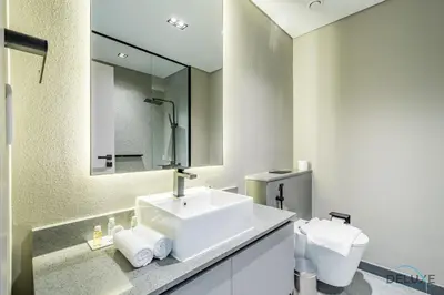 a bathroom with a white sink and a mirror at Appealing Studio in MAG EYE 890, Mohammad Bin Rashid City by Deluxe Holiday Homes in Dubai