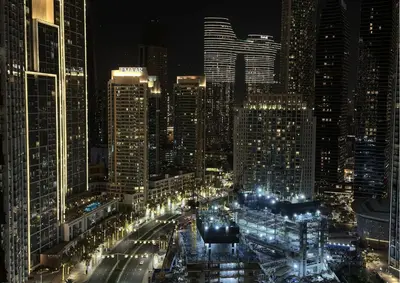 a view of a city at night with lights at Beautiful 2BR I Heart of BLVD I Downtown Dubai in Dubai