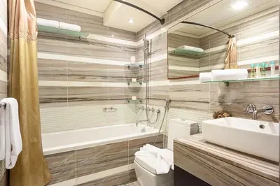 a bathroom with a tub and a toilet and a sink at Luxury loft apartment downtown in Dubai