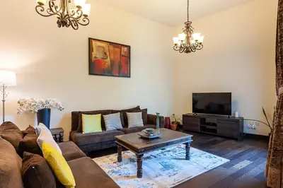 a living room with a couch and a tv at Luxury loft apartment downtown in Dubai