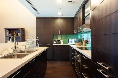 a kitchen with wooden cabinets and a sink at Luxury loft apartment downtown in Dubai