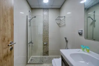 a bathroom with a shower and a sink at ShoresInn - Radiant 1BR in Dubai Marina in Dubai
