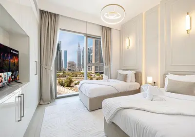 a hotel room with two beds and a large window at Stylish Burj khalifa view 5 Star 4BD Apartment in Downtown with Dubai Mall access - Brand New Apartment in Dubai