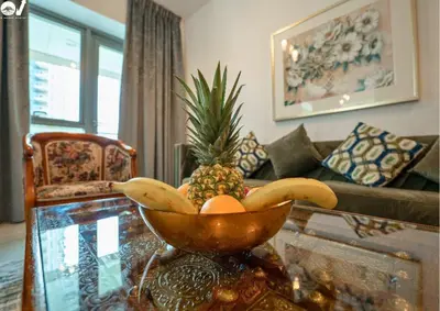 a bowl of fruit on a table in a living room at Luxury 2BR Suite I Garden View I Downtown Dubai in Dubai