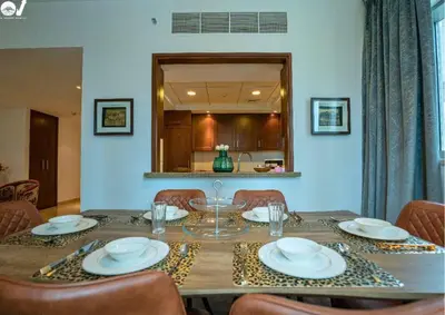 a dining room table with plates and glasses on it at Luxury 2BR Suite I Garden View I Downtown Dubai in Dubai