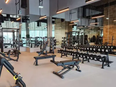 a gym with rows of benches and machines at Luxury Stay at Forte Emaar - 5 Min Walk to Burj in Dubai