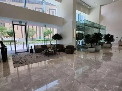 a lobby with couches and a table in a building at Luxury Stay at Forte Emaar - 5 Min Walk to Burj in Dubai