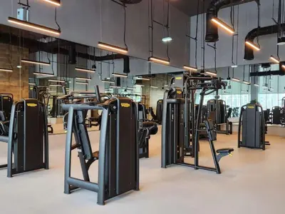 a gym with rows of exercise bikes and treadmills at Luxury Stay at Forte Emaar - 5 Min Walk to Burj in Dubai