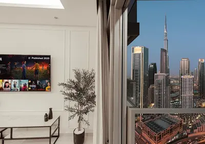 a room with a window with a view of a city at High Floor Apartment in 5 Star Hotel with Infinity Pool Burj View Gym Spa Sauna in Dubai