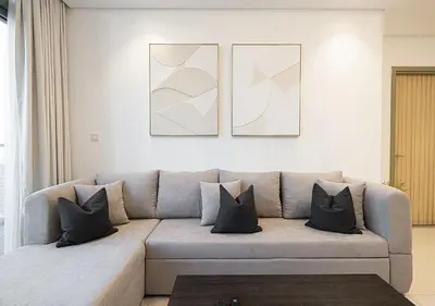 a living room with a couch with pillows at High Floor Apartment in 5 Star Hotel with Infinity Pool Burj View Gym Spa Sauna in Dubai