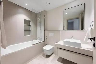a bathroom with a sink toilet and a mirror at 2BR Beachfront Apt with Stunning Dubai Marina View in Dubai