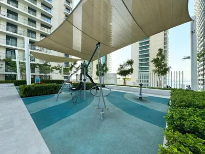 a playground in a building with an umbrella at 2BR Beachfront Apt with Stunning Dubai Marina View in Dubai