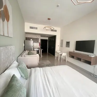 a room with a bed and a living room with a tv at Skyline Studio Apartment with Balcony in Dubai Marina in Dubai