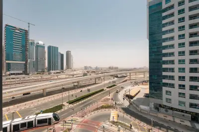 a view of a city with a highway and a bus at Skyline Studio Apartment with Balcony in Dubai Marina in Dubai