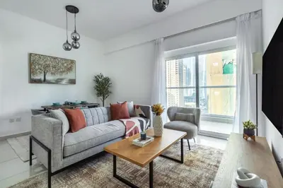 a living room with a couch and a table at ShoresInn - Tranquil 1BR in Dubai Marina in Dubai