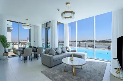 a living room with a couch and a table at Lagoonview 2BR District One in Dubai